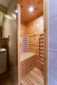 a wooden sauna with a shower and a sink at Marel - apartament 31 sauna Polanica Zdrój in Polanica-Zdrój