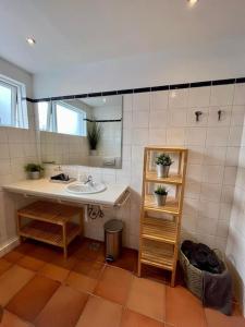 a bathroom with a sink and a mirror at Fell cottage in Reykholt