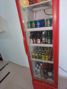 a red refrigerator filled with lots of drinks at hotel xandu in São Paulo