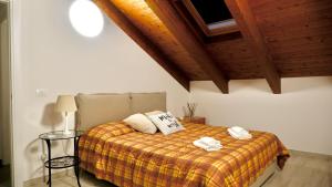 a bedroom with a bed with two towels on it at Attico Deluxe ad Alba - Free parking & Free WiFi -Netflix - Disney in Alba