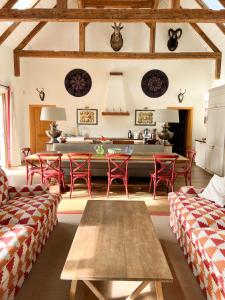 a living room with red chairs and a table at Landhaus Litschau in Litschau