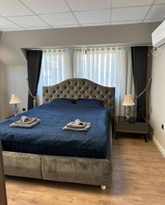 a bedroom with a bed with two towels on it at Apartaments Filipopolis in Plovdiv
