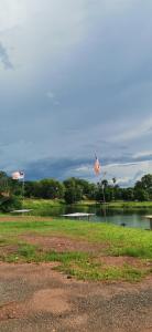 two kites flying in front of a lake at Homestay D'kolam in Pendang
