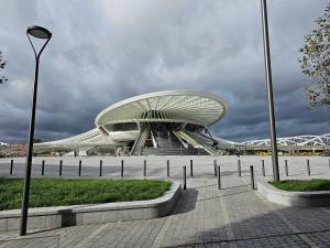 a building with a curved roof in a city at Hotel Le Terminus in Mons +14 photos