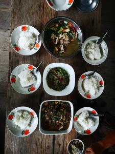 um grupo de pratos de comida numa mesa de madeira em บ้านสวัสดีดอยเต่า 