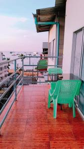 a deck with a green bench on a house at new pind balluchi inn in Pattaya Central