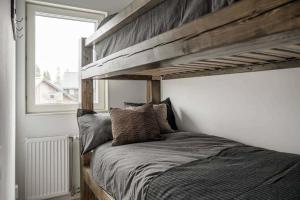 a bedroom with a wooden bunk bed and a window at Fantastisk 7 bädds lägenhet Sälen in Sälen