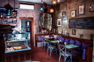a restaurant with tables and chairs in a room at Vila Walter & Son in Poděbrady