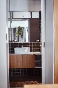 a bathroom with a sink and a mirror at City Apartments at Freedom Plaza in Windhoek