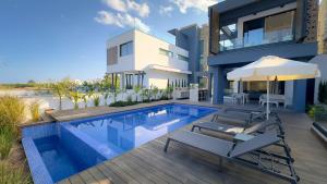 an image of a house with a swimming pool at Sunrise Beachfront Villas - Villa 3 in Paralimni