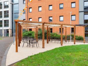 a patio with tables and chairs in front of a building at For Students Only - Marvelous Private Ensuite Rooms at The Forge Sheffield in Sheffield