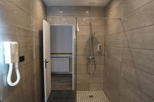 La salle de bains est pourvue d'une douche et d'un téléphone mural. dans l'établissement Hotel Montpensier, à Paris