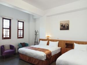 Postel nebo postele na pokoji v ubytování Lukang Inn
