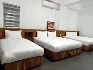 Postel nebo postele na pokoji v ubytování Lukang Inn