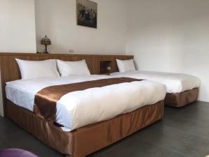 Postel nebo postele na pokoji v ubytování Lukang Inn