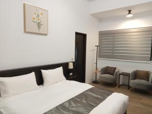 Postel nebo postele na pokoji v ubytování Lukang Inn