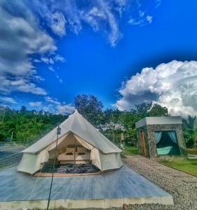 a bell tent with a blue sky in the background at The Wes Village, incl Breakfast and Dinner in Chiang Dao