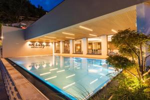 a swimming pool in front of a building at Alpin Chalet am Burgsee in Ladis