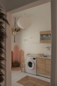a kitchen with a washing machine and a sink at Serendipity in Rhodes Town