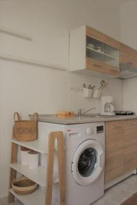a kitchen with a washing machine in a kitchen at Serendipity in Rhodes Town