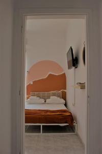 a bedroom with a bed through a doorway at Serendipity in Rhodes Town
