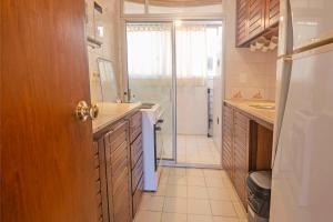 a bathroom with a shower and a sink and a door at Oceana Suites Terrazas del Faro in Punta del Este