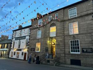 a group of people standing outside of a building at The Western in St Ives