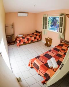 an aerial view of a bedroom with two beds at Pousada Flats Recanto Sonhos do Porto in Porto De Galinhas