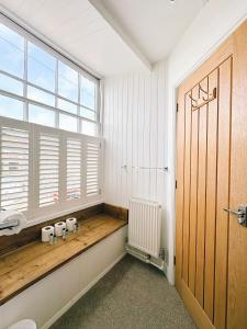 a bathroom with a window with three rolls of toilet paper at The Western in St Ives