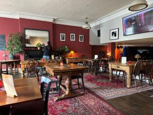 a dining room with wooden tables and chairs at The Western in St Ives