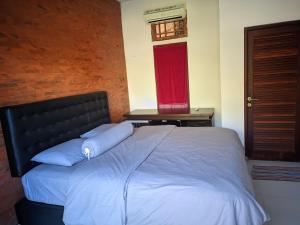 Postel nebo postele na pokoji v ubytování K'Ajeng Cottage