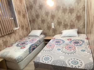 two beds sitting next to each other in a room at Guesthouse Dune in Sofia