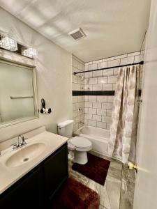 a bathroom with a sink and a toilet and a tub at Cozy Private room with Shared bathroom Inside a house in Phoenix +17 photos