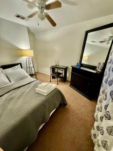 a bedroom with a bed and a large mirror at Modern Private room By Cardinals State Farm stadium in Phoenix