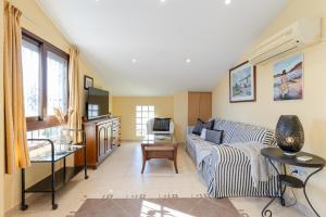 a living room with a couch and a table at Marina Blue by Fidalsa in La Marina +13 photos