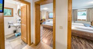 a room with two beds and a mirror at Appartements Am Burgsee in Ladis