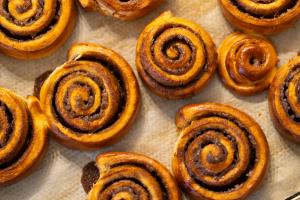 a bunch of cinnamon rolls sitting on a baking sheet at The White Knight Premium Boutique Hotel in Għajnsielem