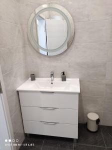 a bathroom with a white sink and a mirror at Apartment Josip in Crveni Vrh