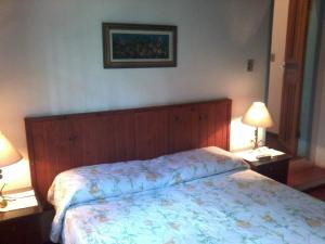 Cama ou camas em um quarto em Pousada Arboretum