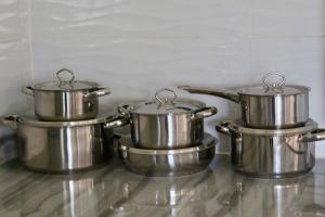 three metal pots sitting on top of a counter at 2 bedroomed house with a lovely garden - 2177 in Umtali