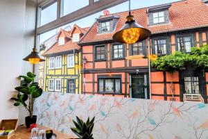 a room with a large window with a building at Uhlpartment - im Herzen von Salzwedel in Salzwedel