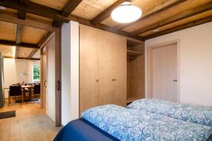 a bedroom with a bed and a dining room at Landluft Ferien - Wohnung Morgentau in Heiligenberg