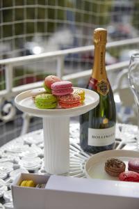 a plate of donuts on a table with a bottle of wine at 81 Promenade Studios in Cheltenham