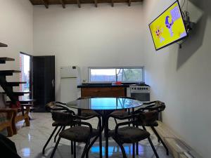 a dining room with a glass table and chairs at House-Mendoza in Maipú