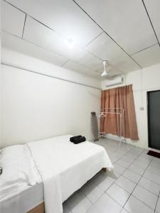 een ziekenhuiskamer met een bed en een tv bij LILY HOMESTAY PUTATAN in Kota Kinabalu
