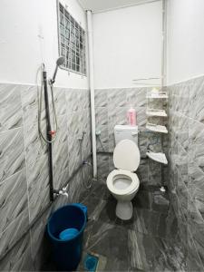 a bathroom with a toilet and a shower at LILY HOMESTAY PUTATAN in Kota Kinabalu
