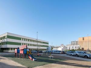 a playground in a parking lot next to a building at Castañuelas in Jerez de la Frontera