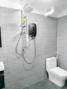 a shower in a bathroom with a toilet at D'Ulu Tehel Homestay Melaka - Private Swimming Pool in Melaka