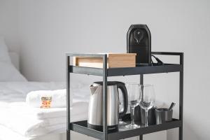 a black shelf with a coffee maker and glasses at home2stay Apartmenthaus Heilbronn City Kitchen Parking Highspeed Wifi Washroom in Heilbronn
