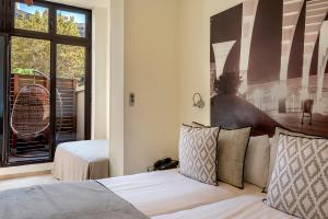 a bedroom with a bed and a large window at Limonaia in Barcelona